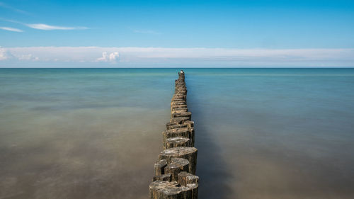 High angle view of wooden posts in sea