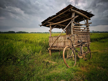 Traditional windmill on field against sky