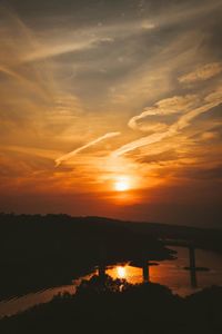 Scenic view of lake against romantic sky at sunset