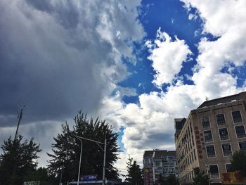 Low angle view of building against cloudy sky