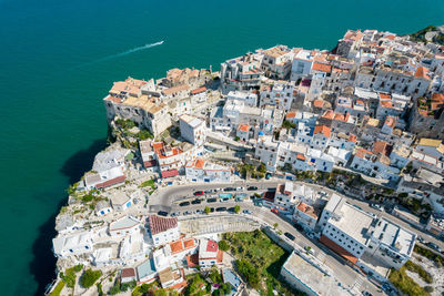 High angle view of buildings and sea in town