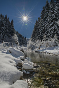 Scenic view of frozen lake against sky during winter