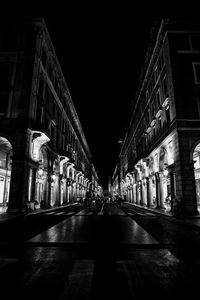 Illuminated road in city at night