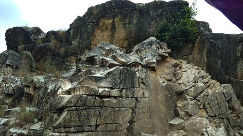 Low angle view of rock formation against sky