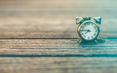Close-up of clock on table