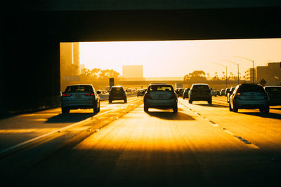 Cars on road at sunset