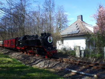 Train on railroad track against sky