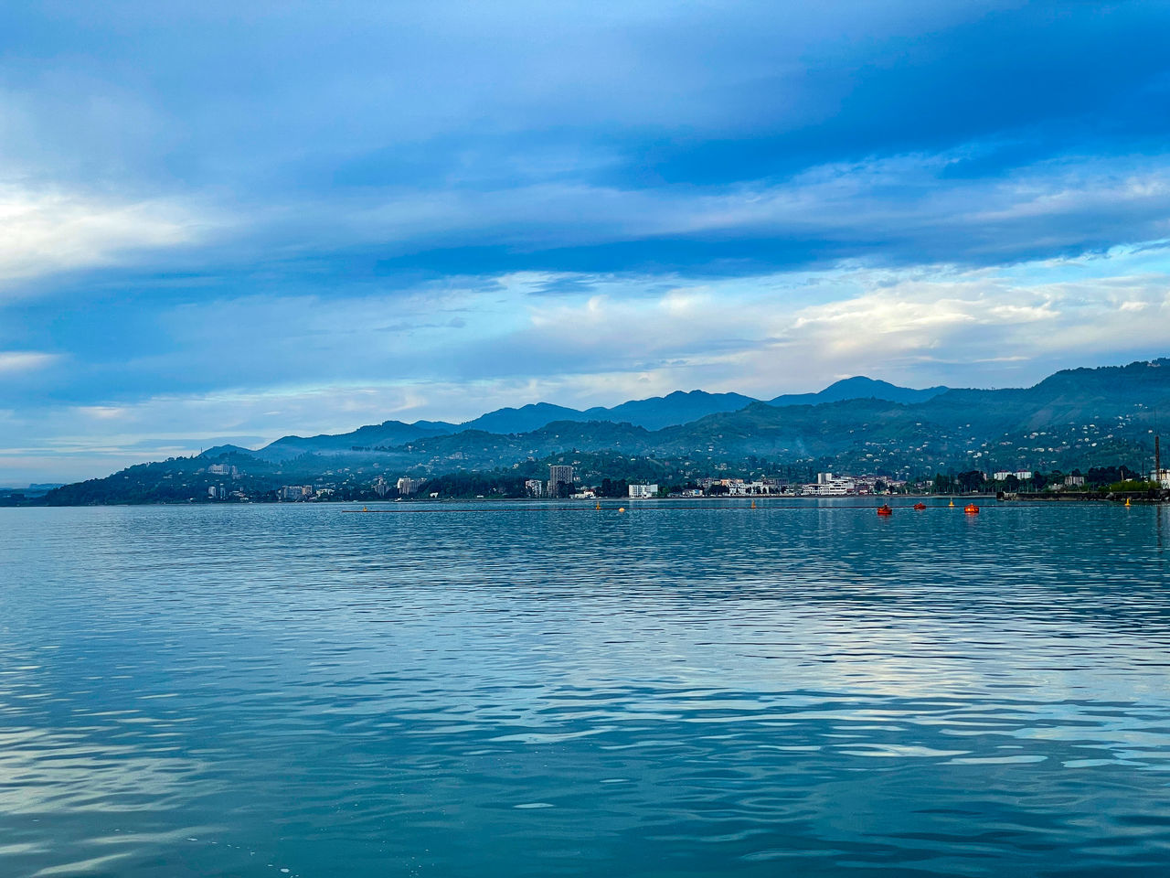 SCENIC VIEW OF BAY AGAINST BLUE SKY