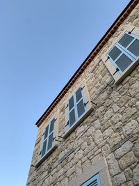 Low angle view of building against clear blue sky