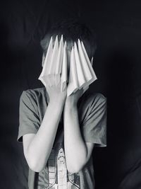 Midsection of a person hiding behind covering face