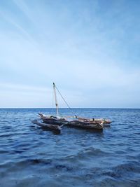 Sailboat in sea against sky