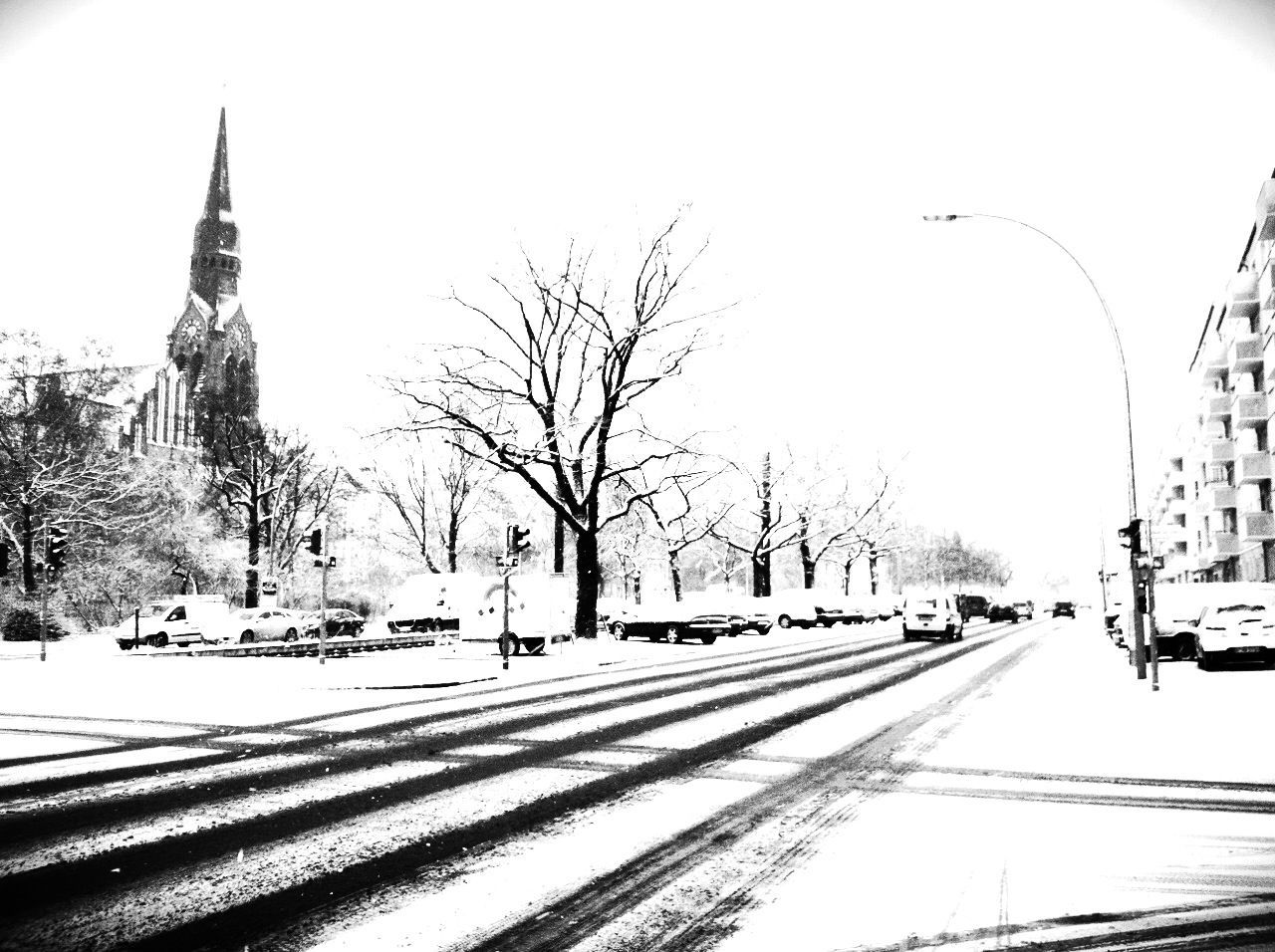 transportation, snow, winter, clear sky, cold temperature, car, road, bare tree, mode of transport, built structure, building exterior, street, tree, season, architecture, land vehicle, the way forward, white color, day, covering