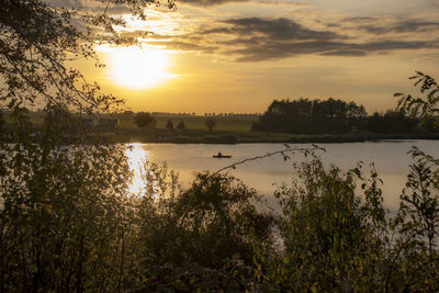 Scenic view of lake against sky during sunset