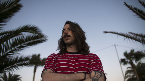 Low angle view of man standing against sky