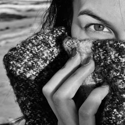 Cropped hand of woman standing on snow