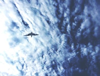 Low angle view of airplane flying in sky