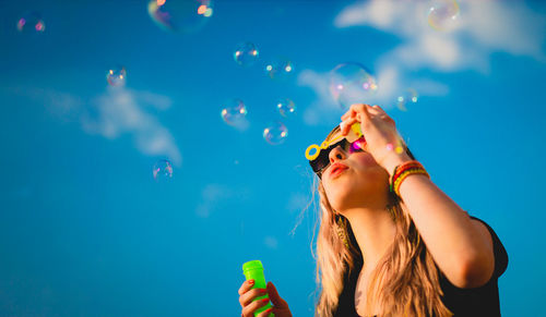 Young woman with bubbles in water