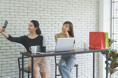 Young woman using laptop on table