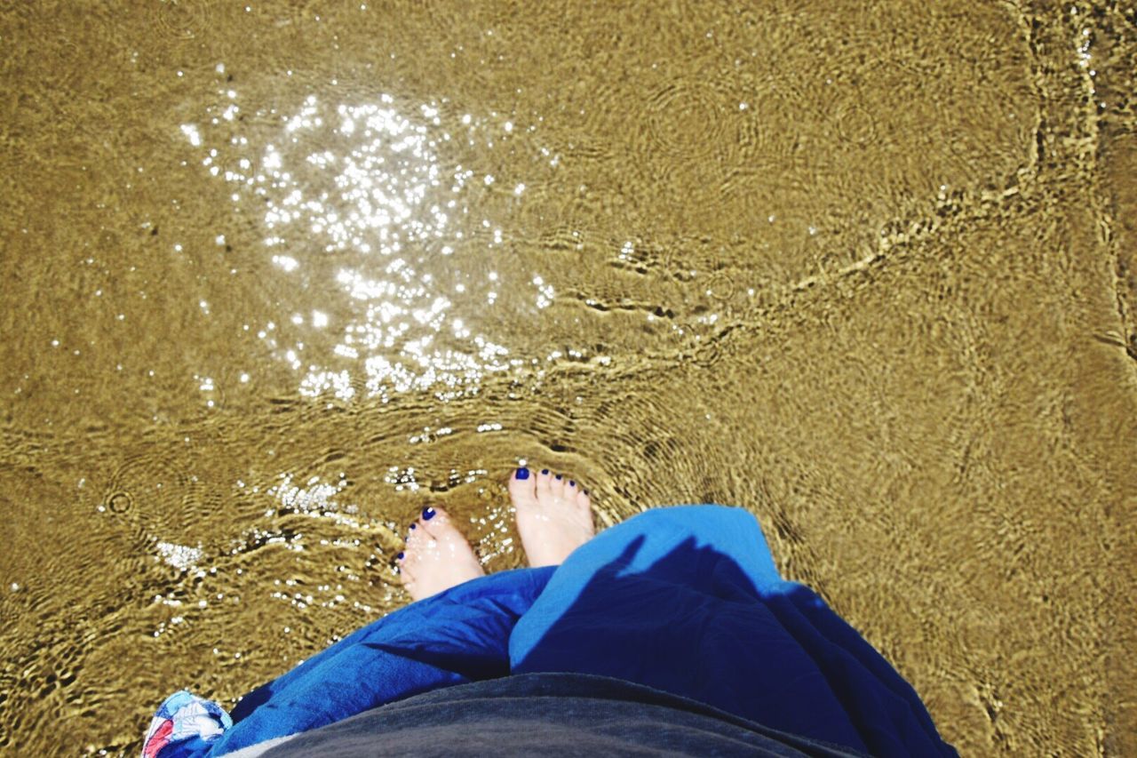 water, low section, person, beach, sand, personal perspective, lifestyles, shore, leisure activity, sea, men, high angle view, human foot, standing, vacations, nature, shoe