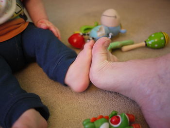 Cropped image of person and baby leg