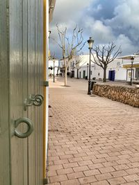 Footpath by building against sky