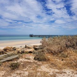 View of beach against cloudy sky
