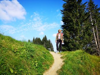 Portrait of mature woman standing on footpath