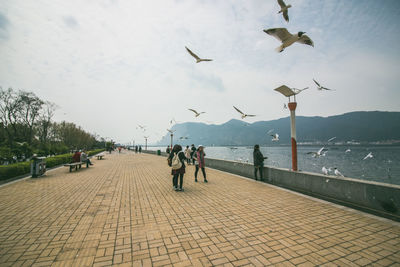 People on footpath against sky