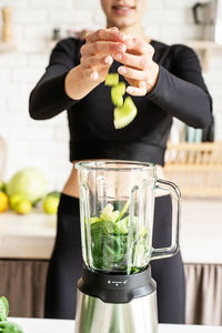 Midsection of woman preparing food in kitchen