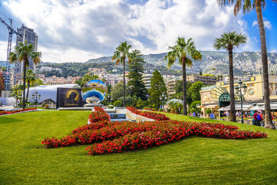 Scenic view of park against cloudy sky