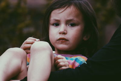 Close-up of girl holding baby hand