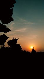 Silhouette of trees against sky at sunset