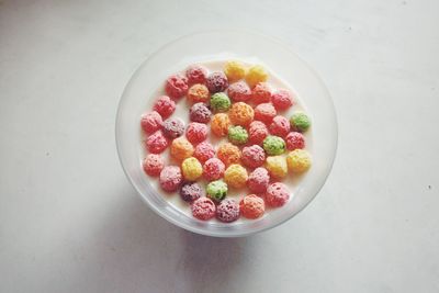 High angle view of colorful cornflakes in milk