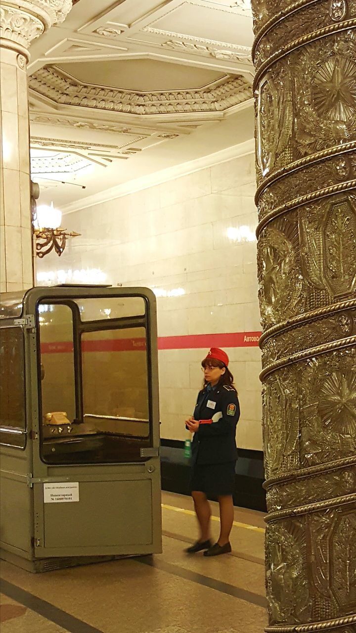 FULL LENGTH OF WOMAN STANDING ON ILLUMINATED BUS