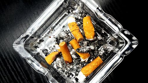 High angle view of cigarette smoking against black background