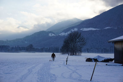 Scenic view of snow covered landscape against sky