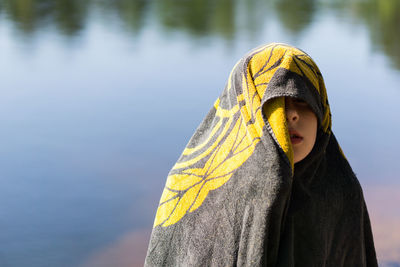 Close-up of boy against water