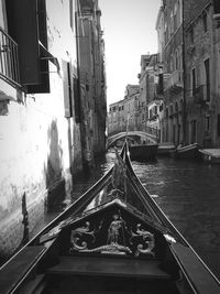 Canal amidst city against sky