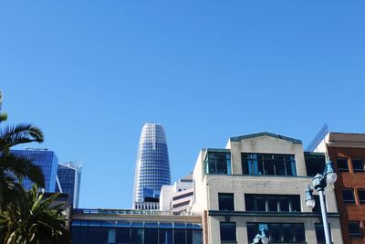 Low angle view of buildings against clear blue sky