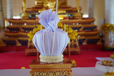 Close-up of cake on table against temple