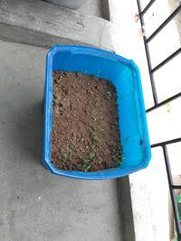 High angle view of blue container on stone wall