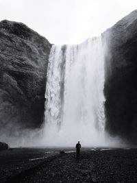 Scenic view of waterfall against sky