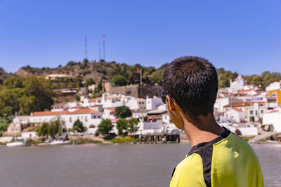 Rear view of man looking at city