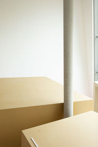 Empty chair by table against wall at home