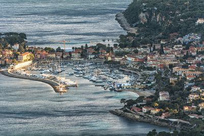 High angle view of sea and buildings in city