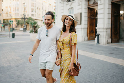 Portrait of young woman standing in city