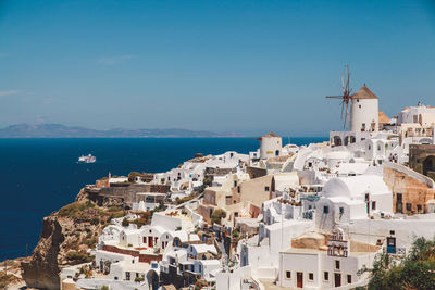 Houses by sea at santorini against sky