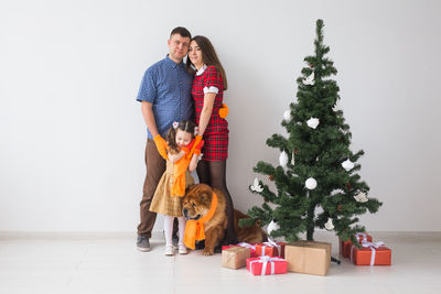 Man and woman holding christmas tree in box
