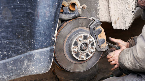 Cropped image of male mechanic repairing car