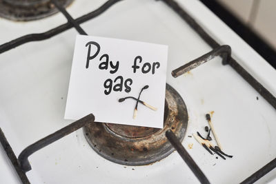 High angle view of text paper over stove